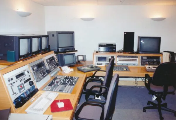A professional edit suite showing multiple computers and monitors in a room.