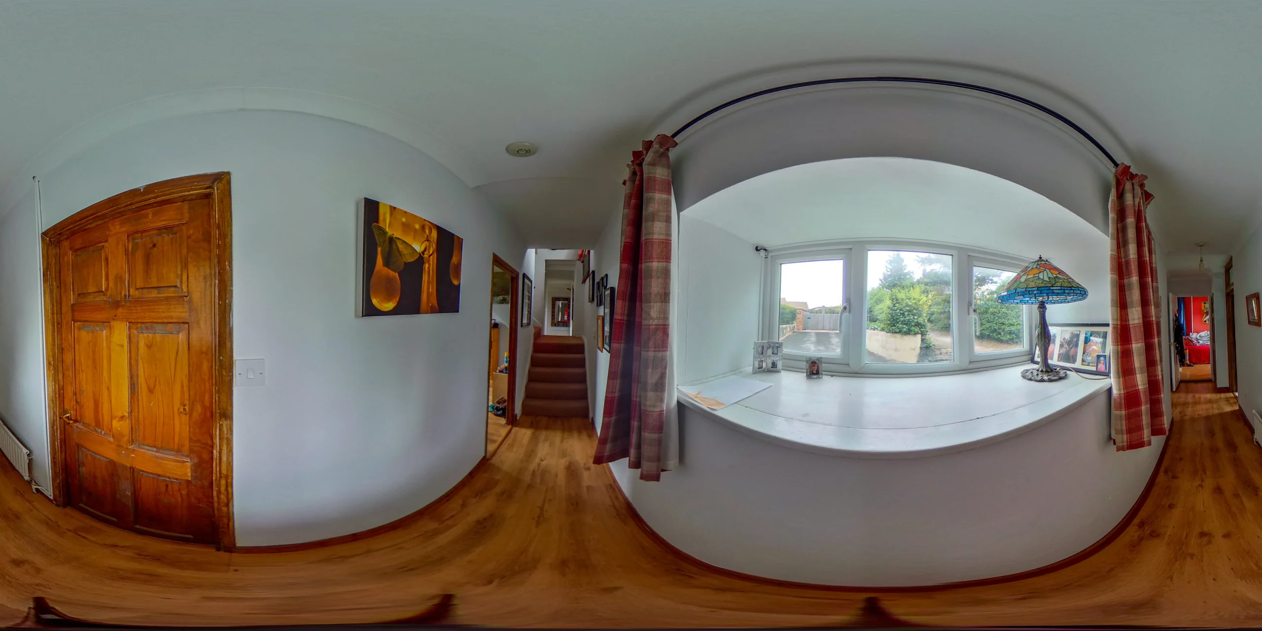 360 Hallway with white walls, a polished wooden floor, and bright lighting.