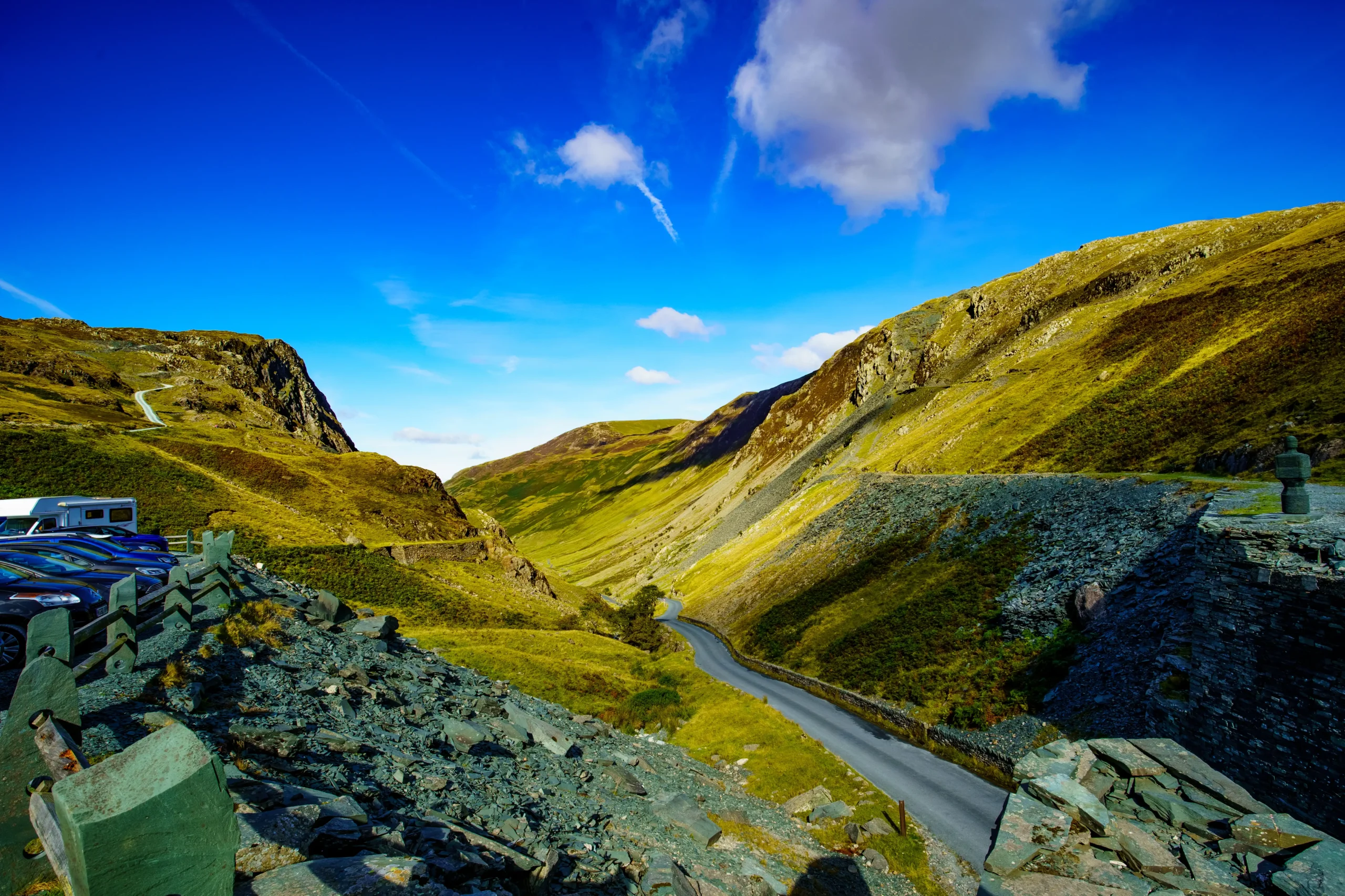 A picturesque mountain road, curving gracefully amidst the majestic peaks, inviting exploration and adventure.