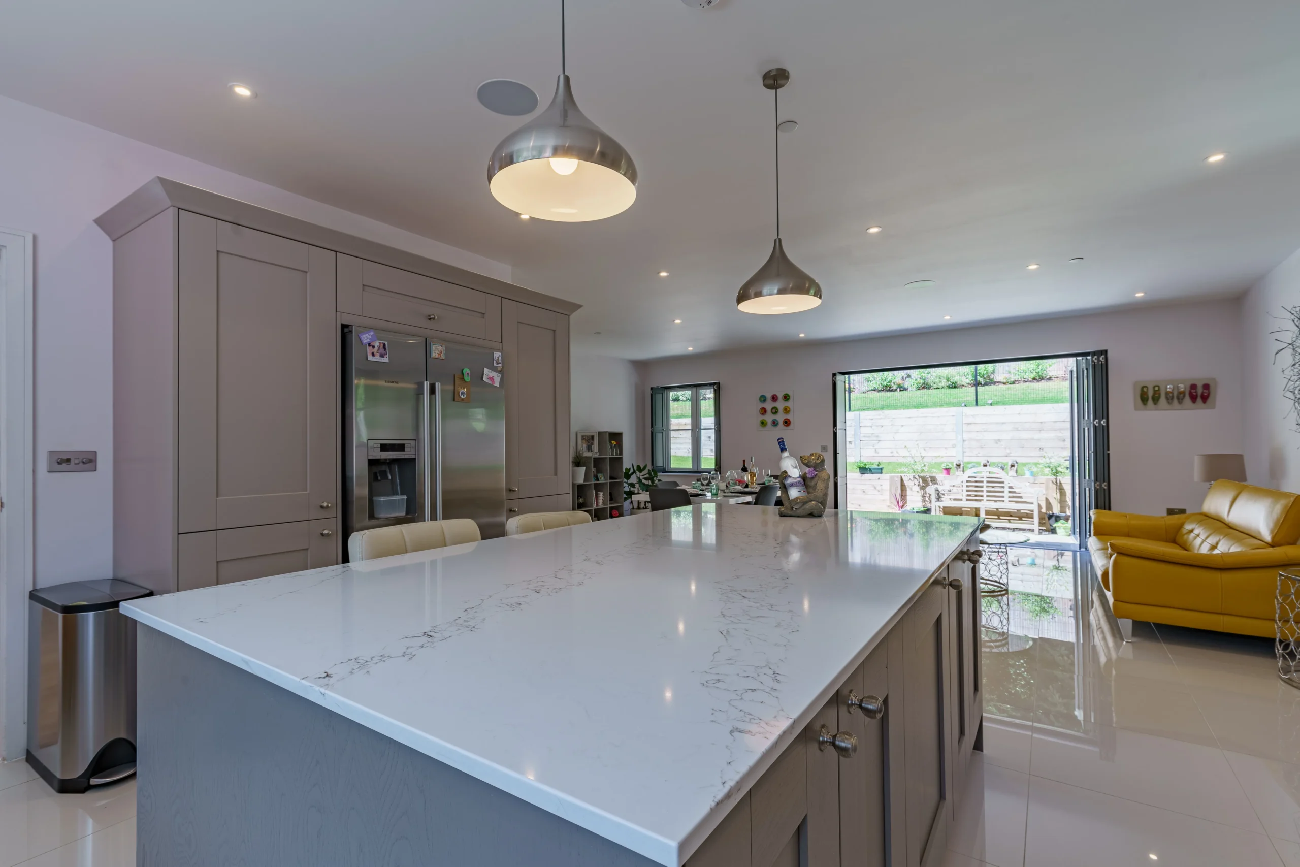 A spacious kitchen featuring a sizable island and a dining area.