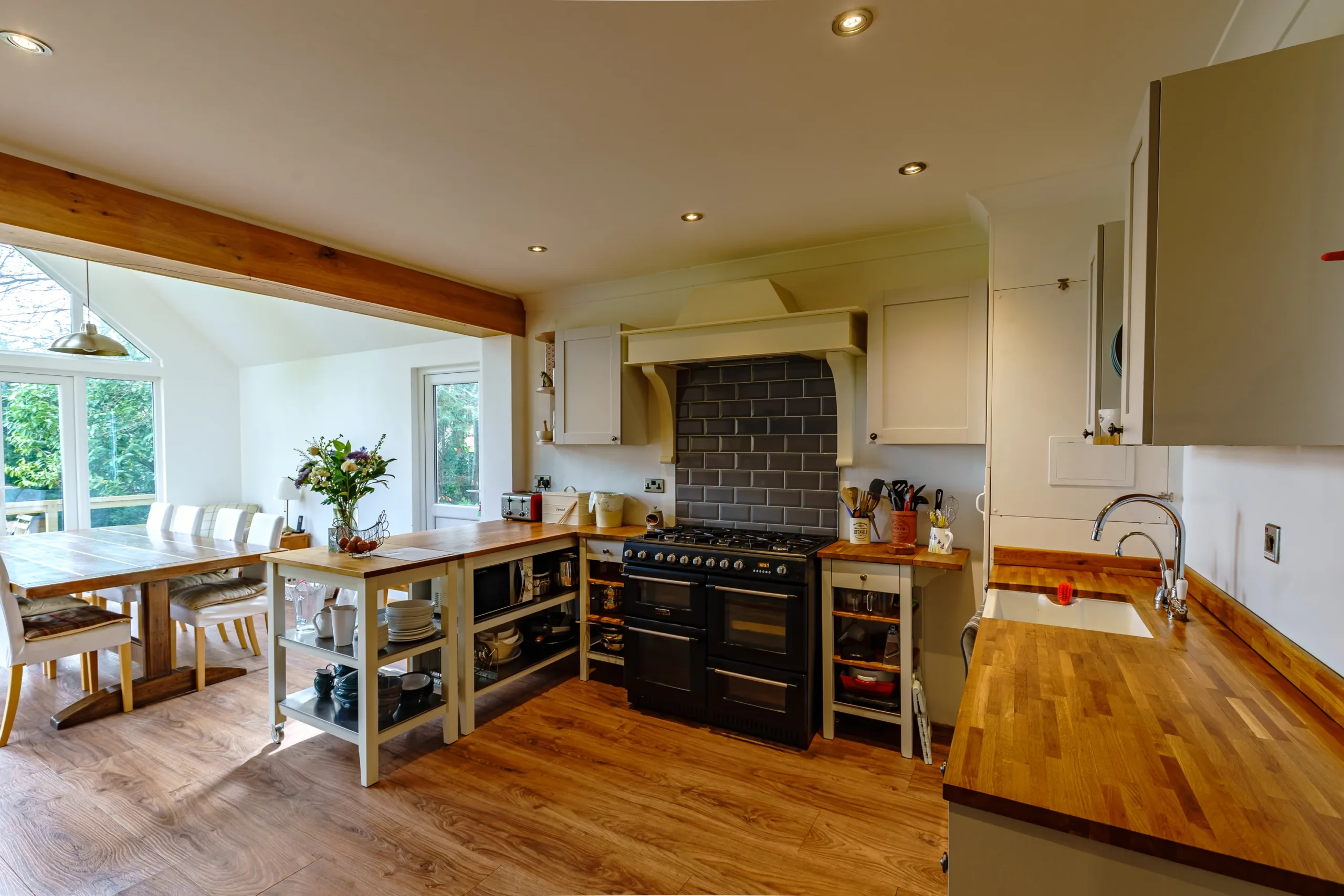 A sleek and contemporary kitchen with stainless steel appliances, wooden countertops, and minimalist design.