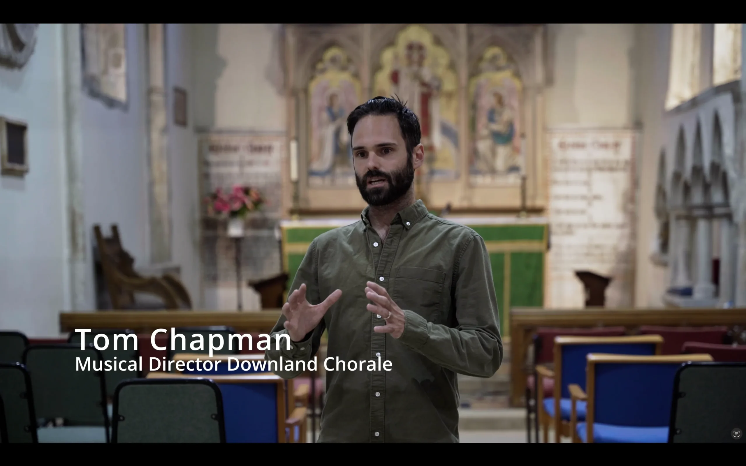 Director Tom engagingly sharing insights about the choir with the camera.