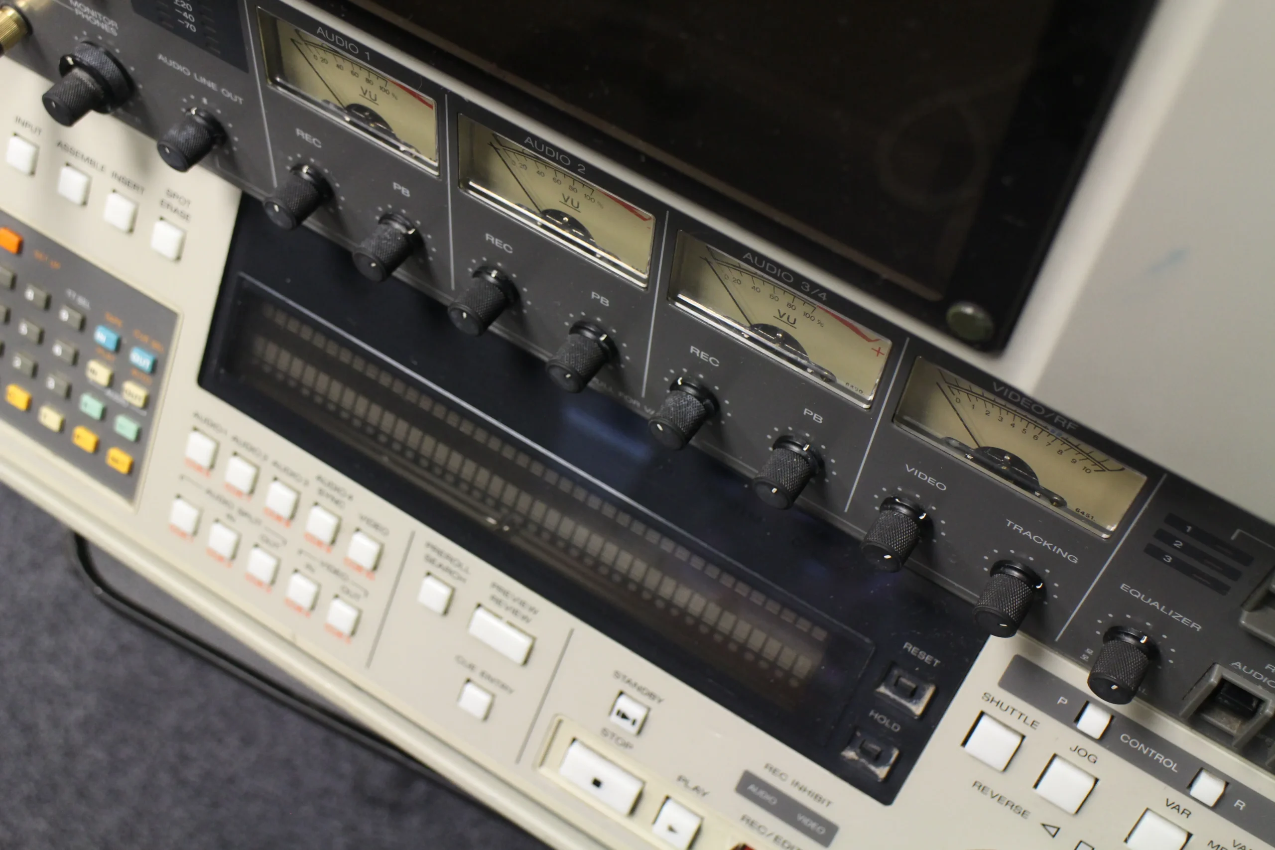 A close-up of a one-inch recording machine with numerous controls.