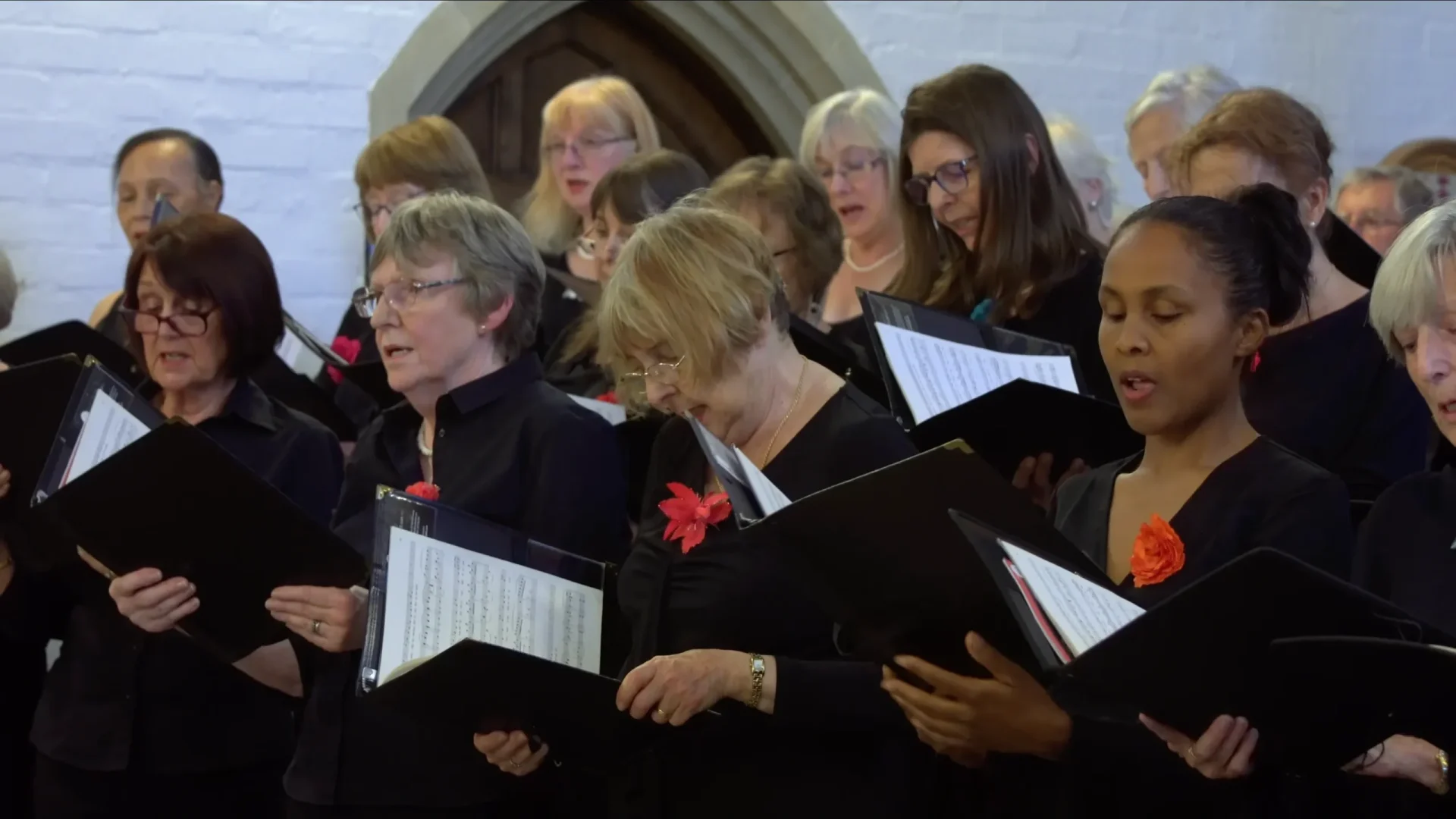 Close-up of choir singing in promotional video.