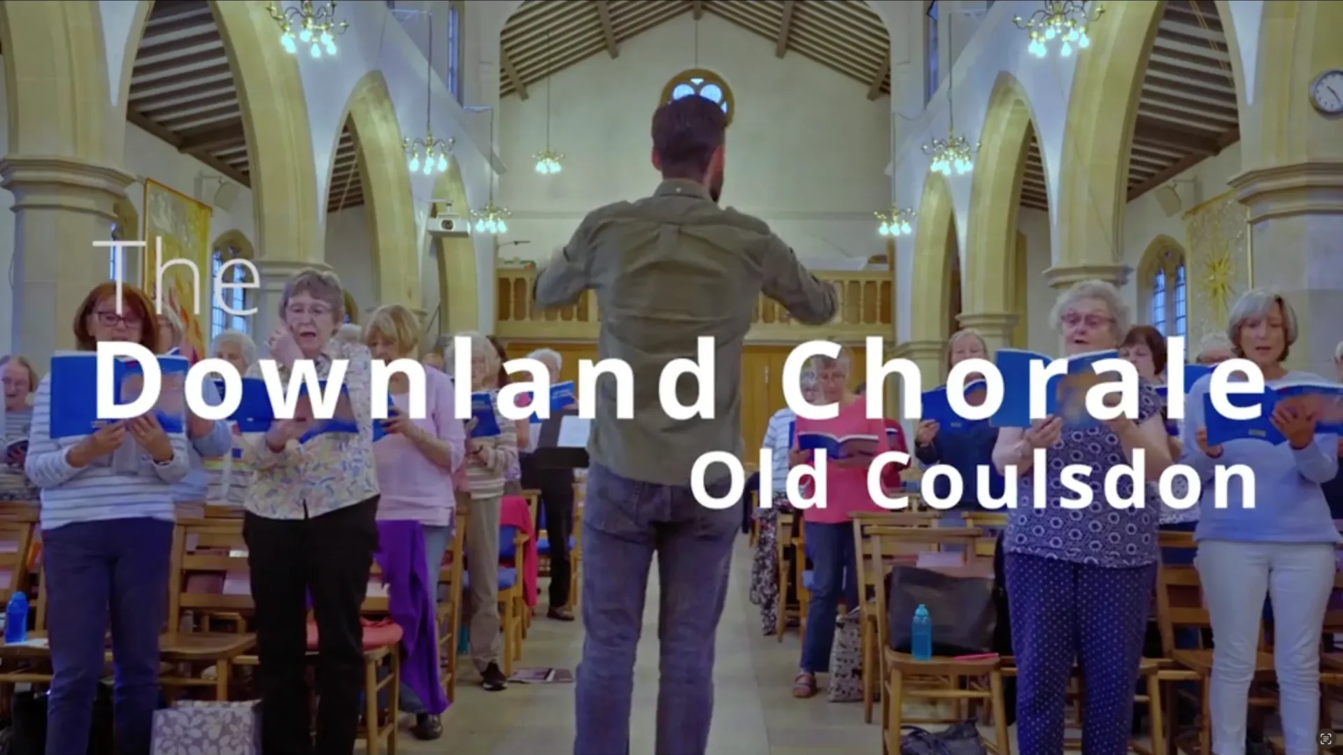 Downland Chorale Choir singing in a church during a promotional event.