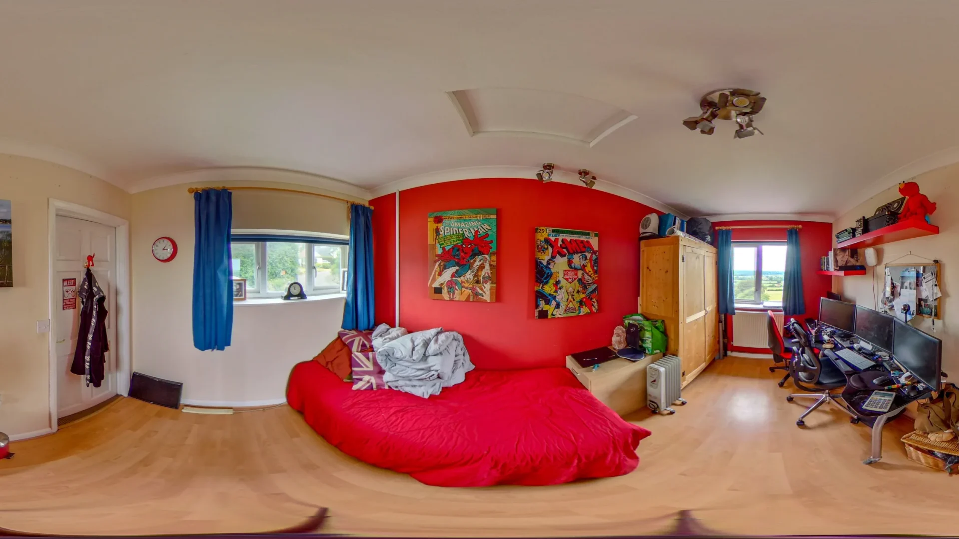 A vibrant kids bedroom with colourful walls and a captivating red bed at its heart, offering a 360-degree view.