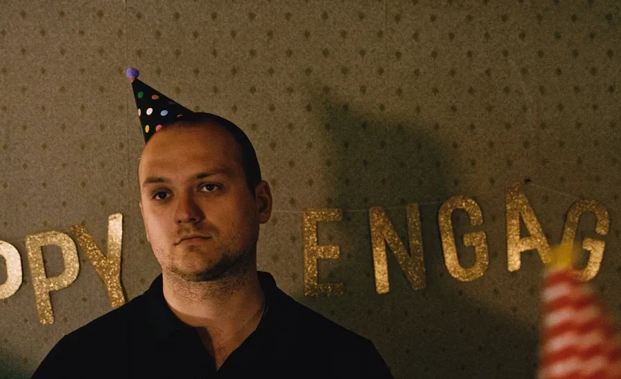 A man wearing a party hat at a party.