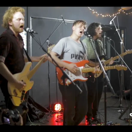 A band performing live in a room.